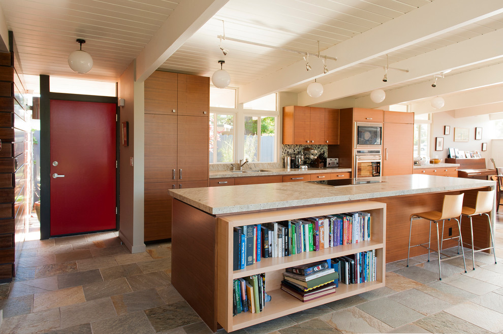 Photo of a large contemporary galley open plan kitchen in San Francisco with a double-bowl sink, flat-panel cabinets, medium wood cabinets, granite benchtops, multi-coloured splashback, stone tile splashback, stainless steel appliances, slate floors, with island and multi-coloured floor.