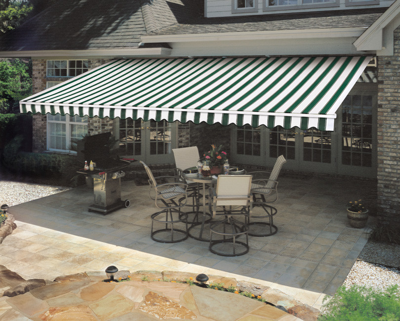 Design ideas for a mid-sized traditional backyard patio in Other with an awning and tile.
