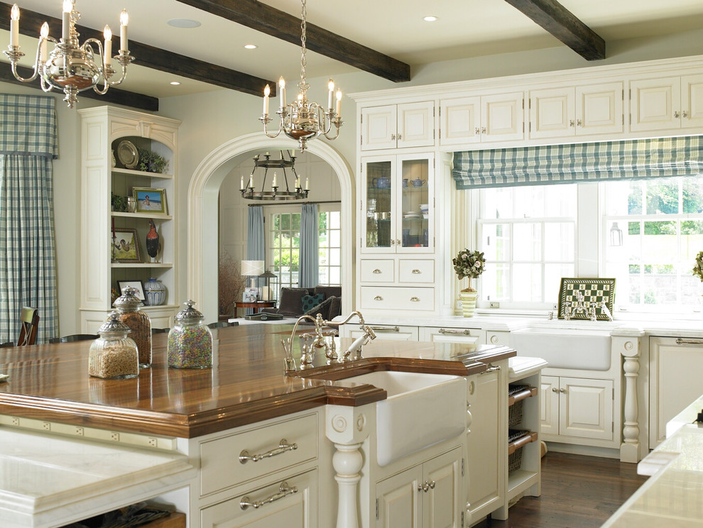 Inspiration for a large country u-shaped eat-in kitchen in New York with a farmhouse sink, recessed-panel cabinets, dark hardwood floors and with island.