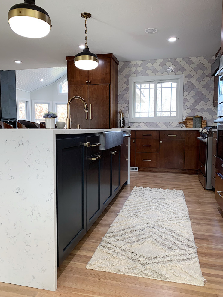 Inspiration for a large midcentury l-shaped open plan kitchen in Minneapolis with a drop-in sink, flat-panel cabinets, dark wood cabinets, onyx benchtops, white splashback, ceramic splashback, stainless steel appliances, dark hardwood floors, with island, brown floor and white benchtop.