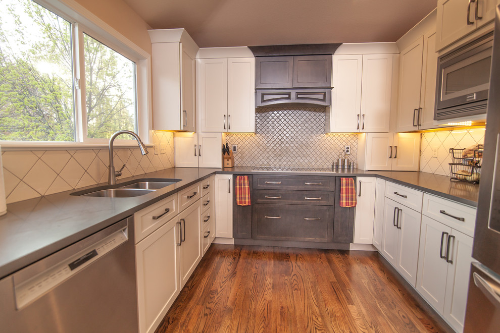 Inspiration for a mid-sized transitional u-shaped light wood floor eat-in kitchen remodel in Boise with a double-bowl sink, shaker cabinets, white cabinets, quartz countertops, white backsplash, ceramic backsplash, stainless steel appliances and an island