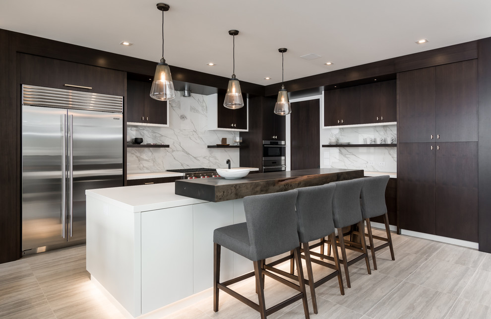 Design ideas for a contemporary l-shaped open plan kitchen in Vancouver with flat-panel cabinets, dark wood cabinets, white splashback, marble splashback, stainless steel appliances, with island and beige floor.