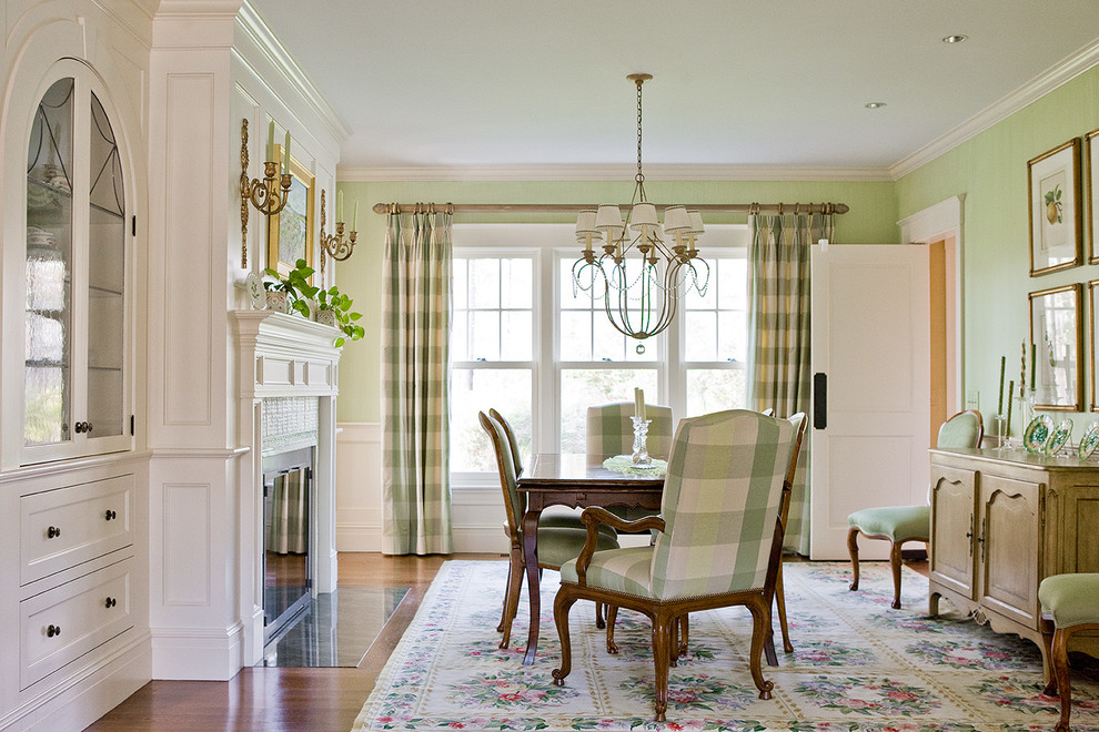 Photo of a mid-sized traditional separate dining room in Boston with green walls, medium hardwood floors and a standard fireplace.