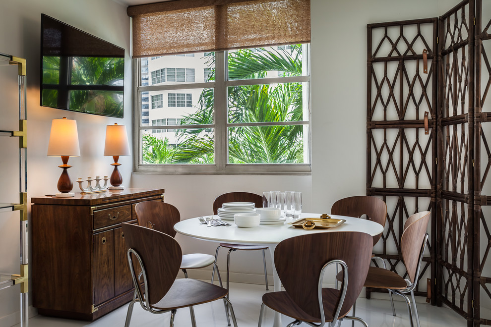 Design ideas for a small tropical dining room in Miami with white walls, porcelain floors and white floor.