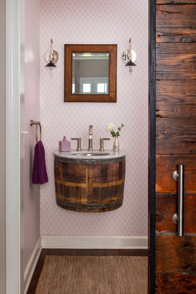 Inspiration for a mid-sized contemporary powder room in Other with purple walls, bamboo floors, a trough sink, marble benchtops, brown floor and white benchtops.
