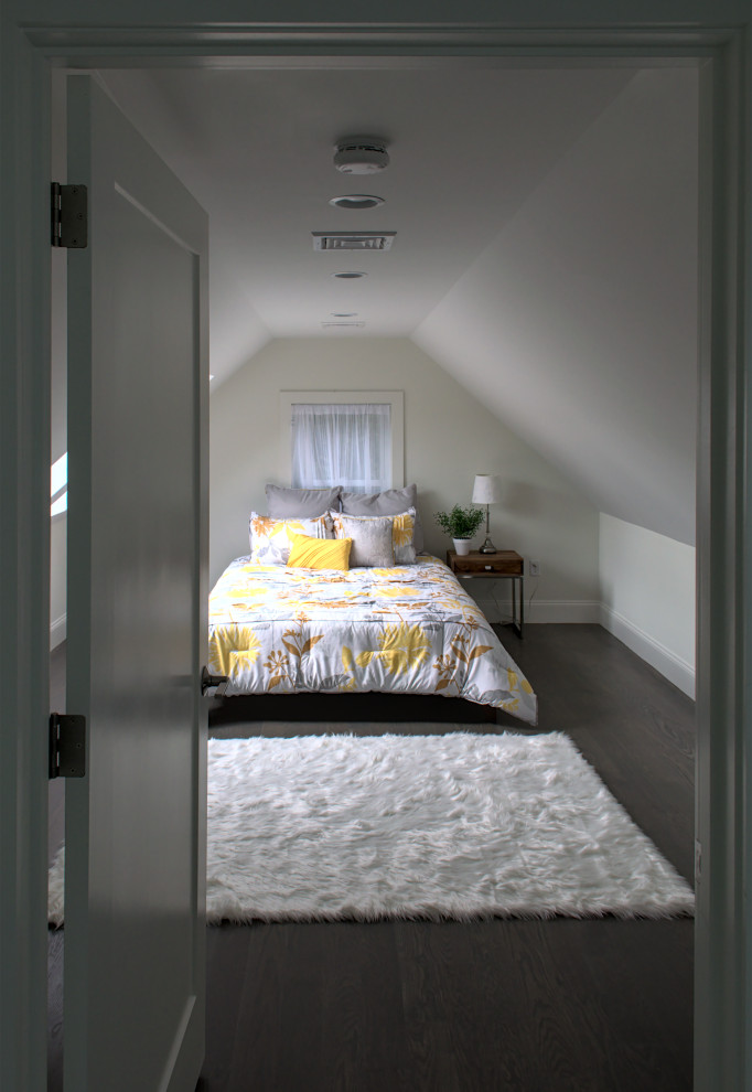 Photo of a small contemporary bedroom in Boston with white walls, dark hardwood floors, grey floor and vaulted.