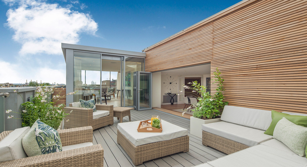 Mid-sized contemporary rooftop and rooftop deck in London with a container garden and no cover.