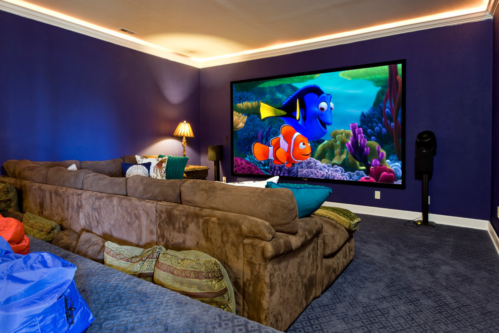 This is an example of a traditional home theatre in Seattle with a projector screen and blue floor.