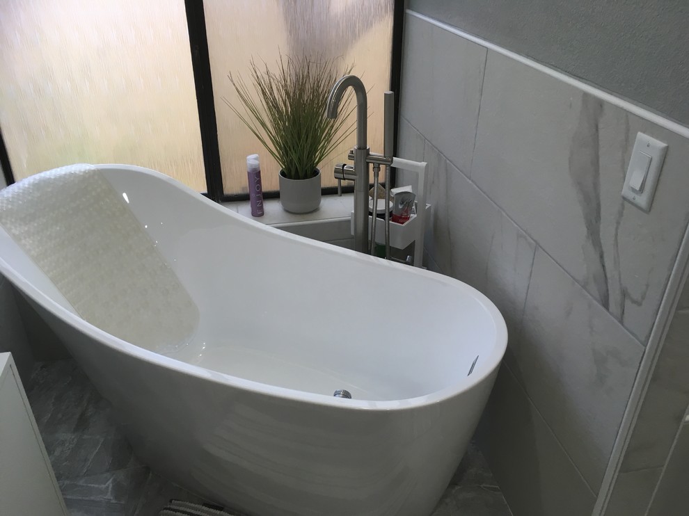 Inspiration for an expansive contemporary master bathroom in Las Vegas with flat-panel cabinets, white cabinets, a hot tub, a curbless shower, a bidet, white tile, ceramic tile, multi-coloured walls, ceramic floors, an undermount sink, quartzite benchtops, multi-coloured floor, an open shower and white benchtops.