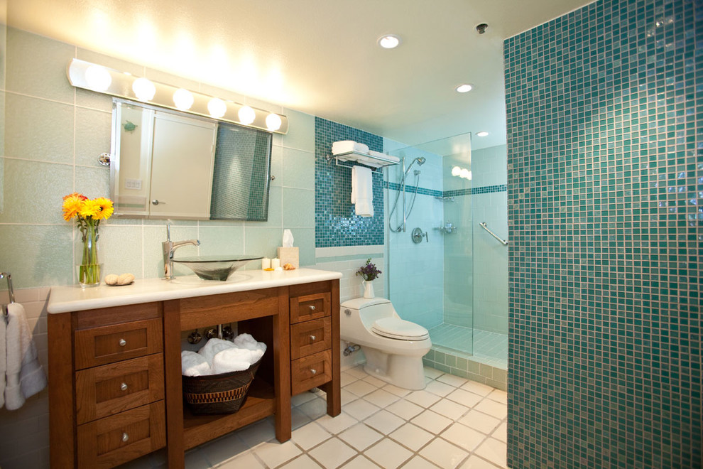 Inspiration for an eclectic bathroom in Los Angeles with a vessel sink, shaker cabinets, medium wood cabinets, an alcove shower, a one-piece toilet, blue tile and mosaic tile.