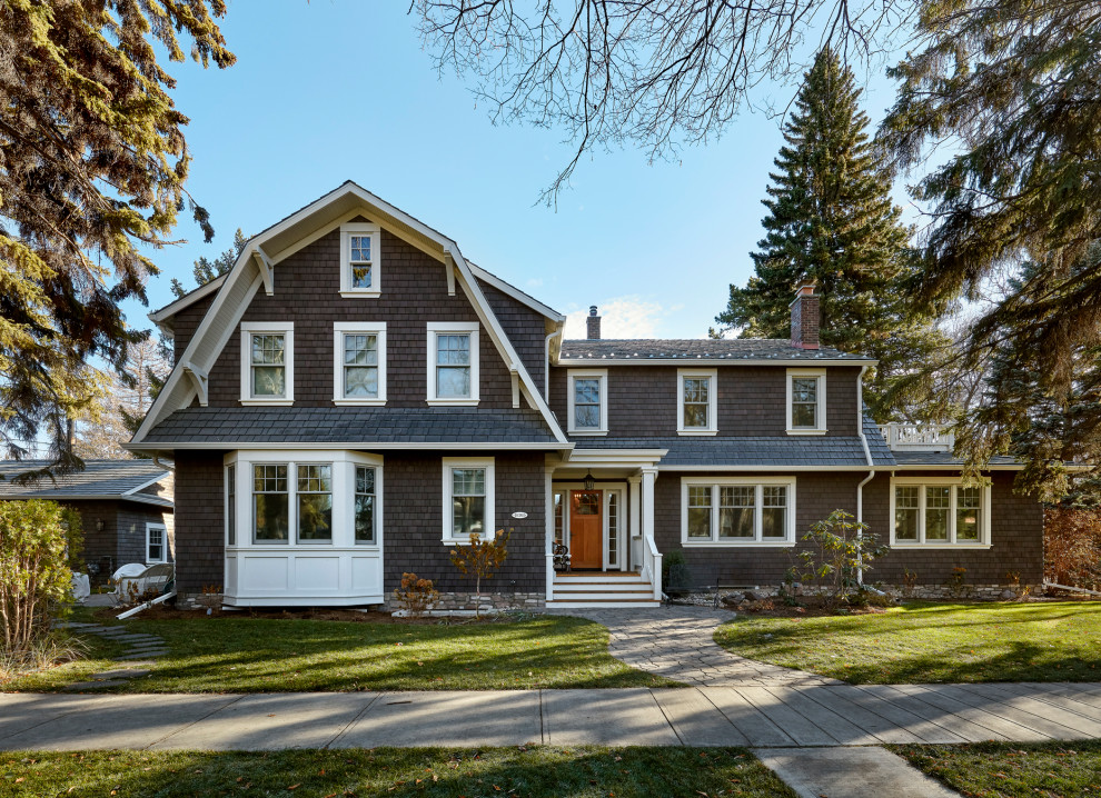 Elegant gray three-story wood and shingle house exterior photo in Calgary with a gambrel roof, a shingle roof and a gray roof
