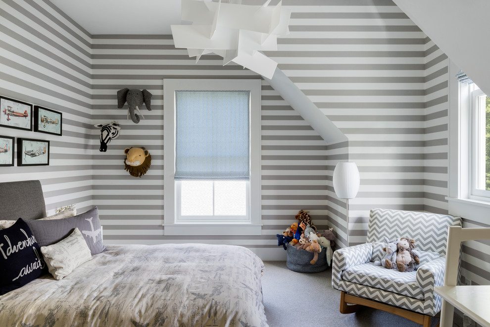 Photo of a transitional gender-neutral kids' bedroom for kids 4-10 years old in New York with grey walls, carpet and grey floor.