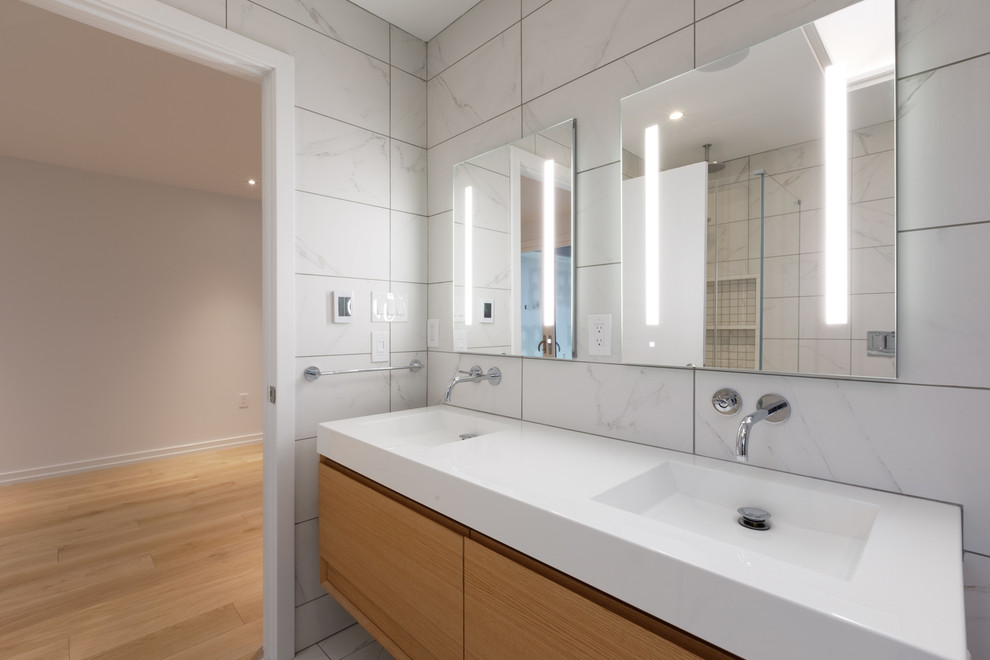 Inspiration for a contemporary master bathroom in Philadelphia with flat-panel cabinets, medium wood cabinets, a double shower, a one-piece toilet, white tile, marble, white walls, marble floors, a wall-mount sink, quartzite benchtops, white floor and a hinged shower door.