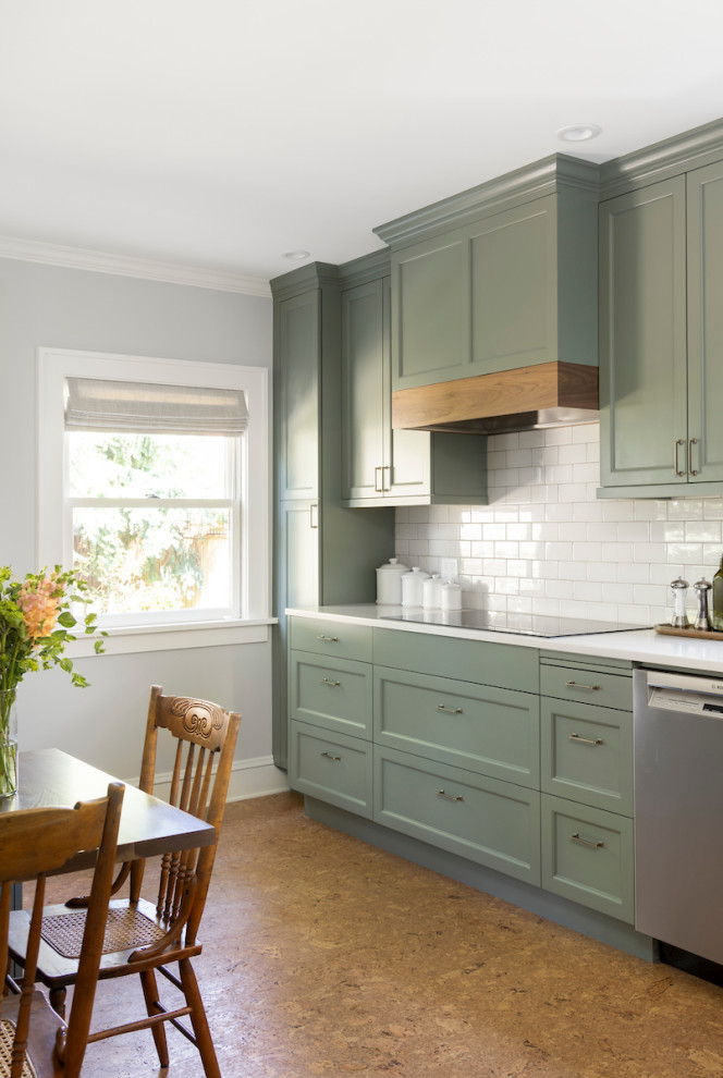 Design ideas for a mid-sized traditional u-shaped eat-in kitchen in Portland with an undermount sink, shaker cabinets, green cabinets, quartz benchtops, white splashback, cement tile splashback, stainless steel appliances, cork floors, no island, brown floor and white benchtop.