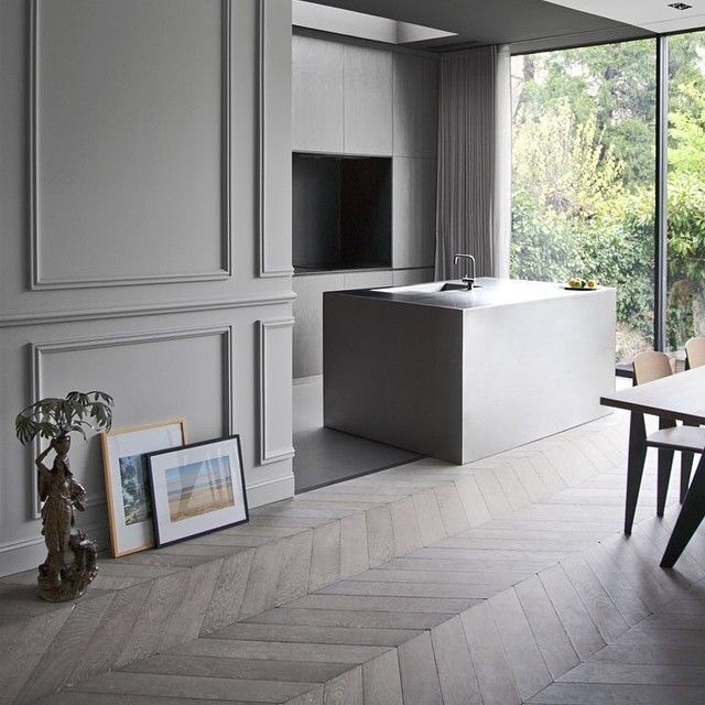 Mid-sized scandinavian l-shaped open plan kitchen in Nuremberg with an integrated sink, flat-panel cabinets, beige cabinets, concrete benchtops, beige splashback, painted wood floors and with island.