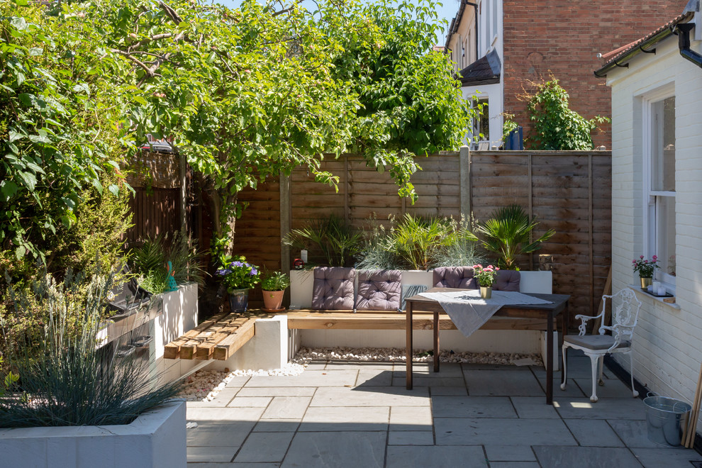 This is an example of a small contemporary garden in London with a container garden.