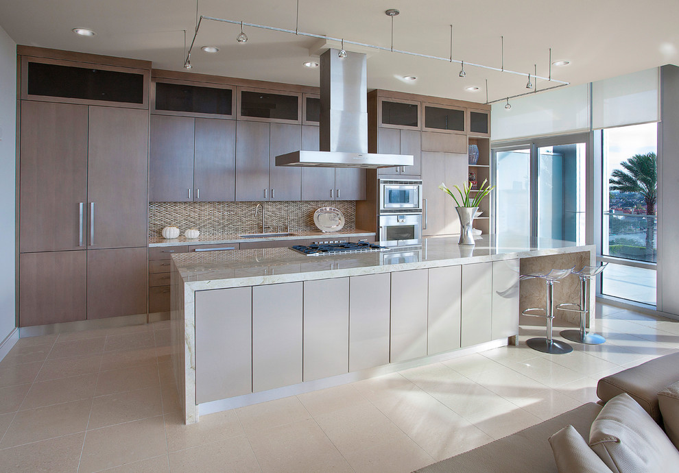 Inspiration for a large contemporary single-wall open plan kitchen in Houston with an undermount sink, flat-panel cabinets, stainless steel appliances, beige cabinets, quartzite benchtops, beige splashback, with island and white floor.