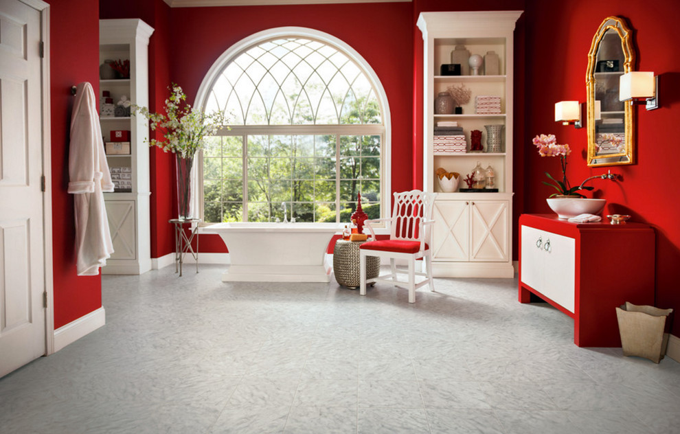 Inspiration for a large transitional master porcelain tile freestanding bathtub remodel with flat-panel cabinets, white cabinets, red walls, a vessel sink and solid surface countertops