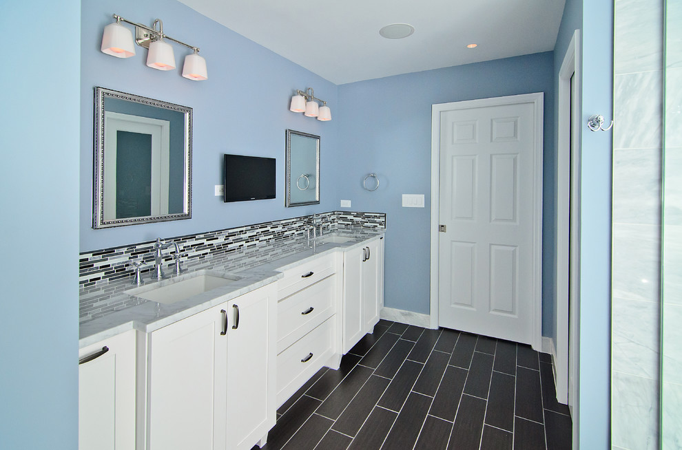 Example of a large transitional master white tile and stone tile porcelain tile double shower design in Chicago with an undermount sink, recessed-panel cabinets, white cabinets, marble countertops, a two-piece toilet and blue walls