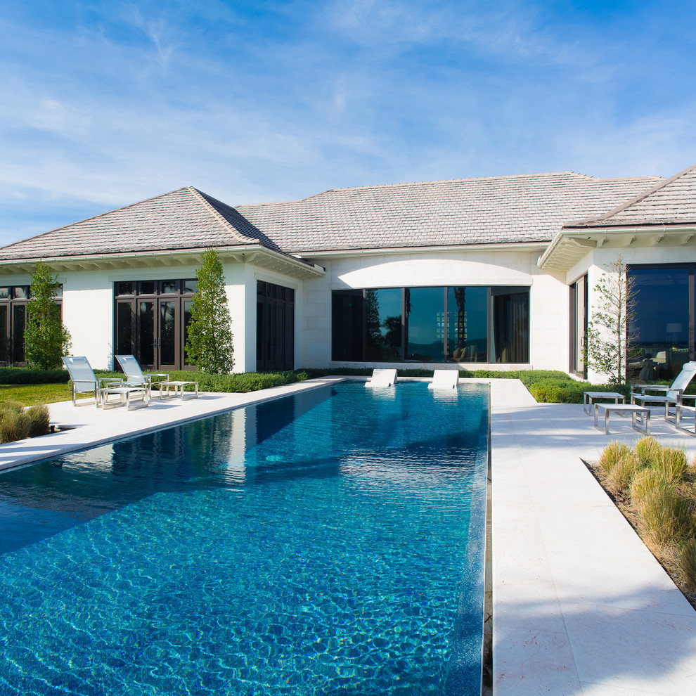 Expansive transitional backyard rectangular pool in Orlando with a pool house.