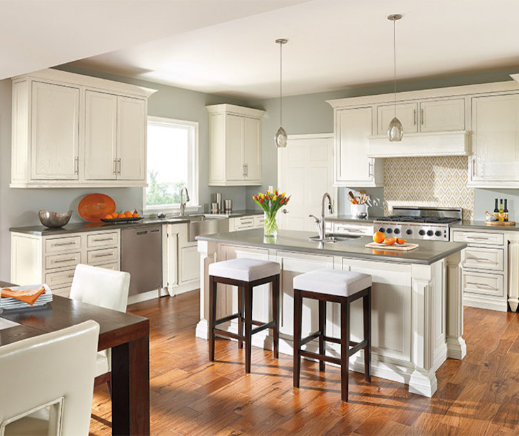 Mid-sized transitional l-shaped dark wood floor and brown floor eat-in kitchen photo in Orange County with an undermount sink, recessed-panel cabinets, white cabinets, concrete countertops, multicolored backsplash, cement tile backsplash, stainless steel appliances and an island