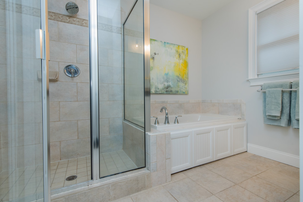 Photo of a transitional master bathroom in Atlanta with beaded inset cabinets, white cabinets, a hot tub, a double shower, a two-piece toilet, multi-coloured tile, ceramic tile, grey walls, ceramic floors, an undermount sink, engineered quartz benchtops, beige floor, a hinged shower door and grey benchtops.