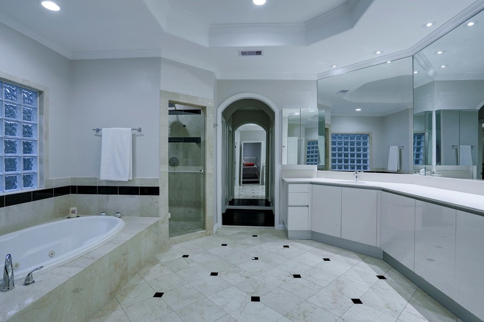 Design ideas for a contemporary master bathroom in Houston with flat-panel cabinets, white cabinets and engineered quartz benchtops.