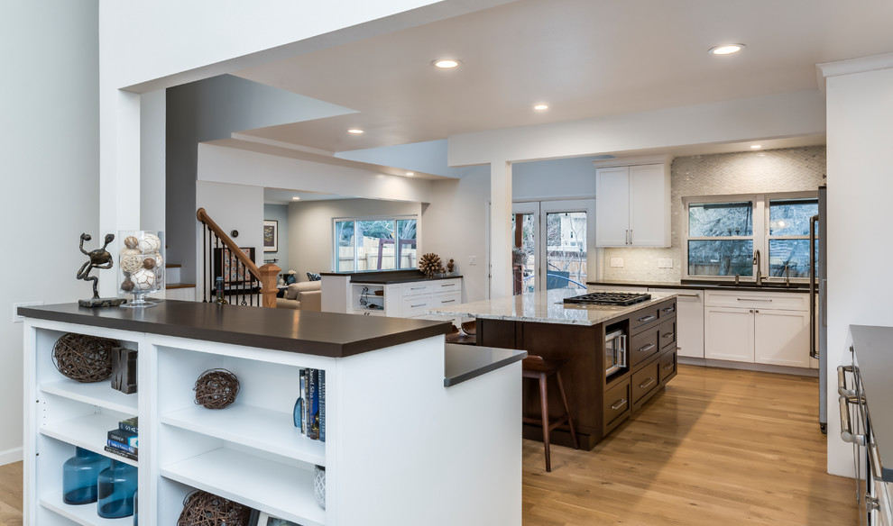 Large transitional light wood floor eat-in kitchen photo in Denver with a single-bowl sink, shaker cabinets, white cabinets, quartz countertops, white backsplash, marble backsplash, stainless steel appliances, two islands and gray countertops