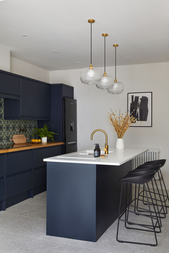 Mid-sized contemporary galley eat-in kitchen in Other with a double-bowl sink, flat-panel cabinets, blue cabinets, solid surface benchtops, green splashback, ceramic splashback, stainless steel appliances, porcelain floors, with island, white floor and multi-coloured benchtop.