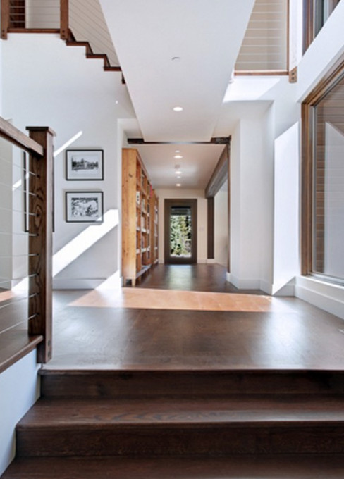 Hallway - mid-sized rustic dark wood floor and brown floor hallway idea with white walls