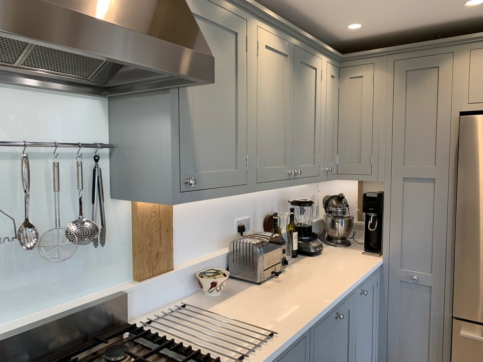 Open plan grey kitchen/diner with large contrasting blue island