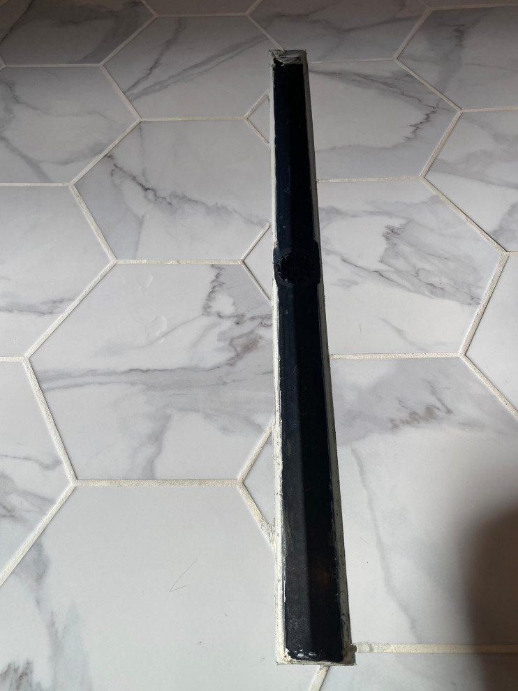 Horrible smelling caulk in shower drain system?