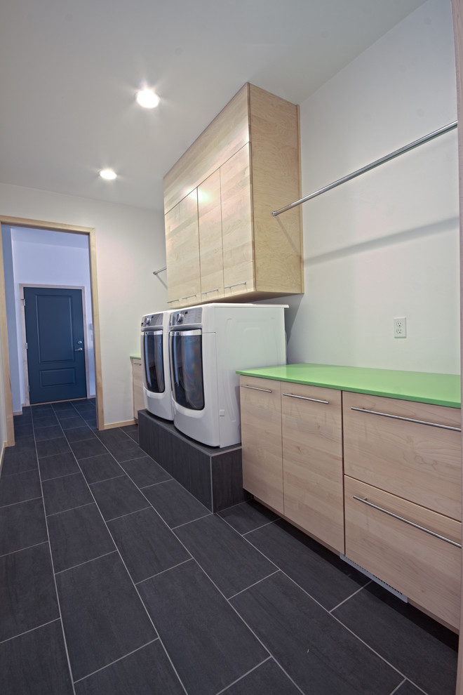 Design ideas for a mid-sized modern single-wall dedicated laundry room in Other with an undermount sink, flat-panel cabinets, light wood cabinets, quartz benchtops, white walls, ceramic floors, a side-by-side washer and dryer and green benchtop.