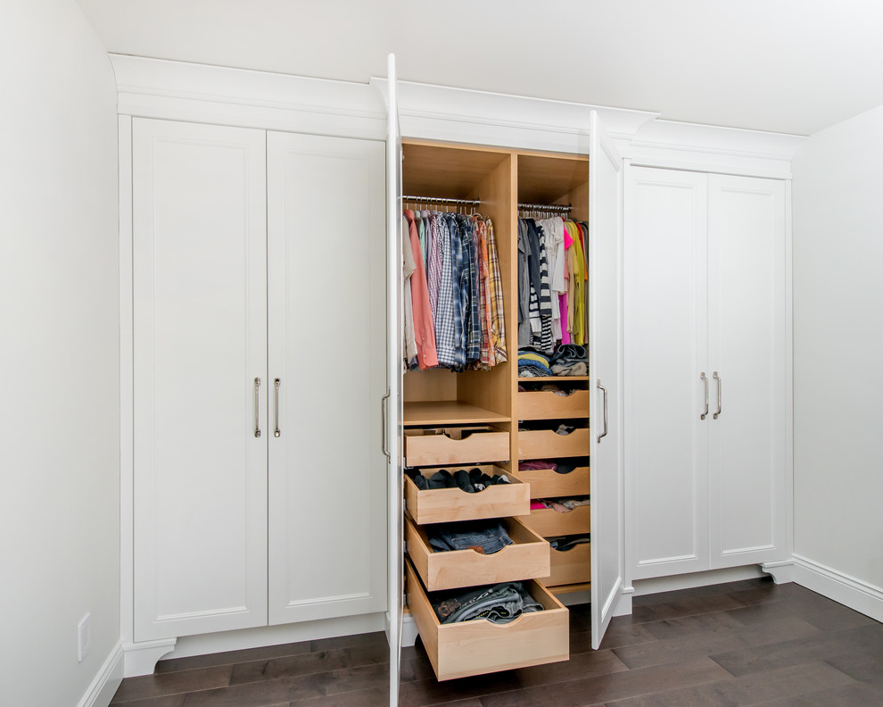 This is an example of a large transitional gender-neutral built-in wardrobe in Edmonton with recessed-panel cabinets, white cabinets, dark hardwood floors and brown floor.