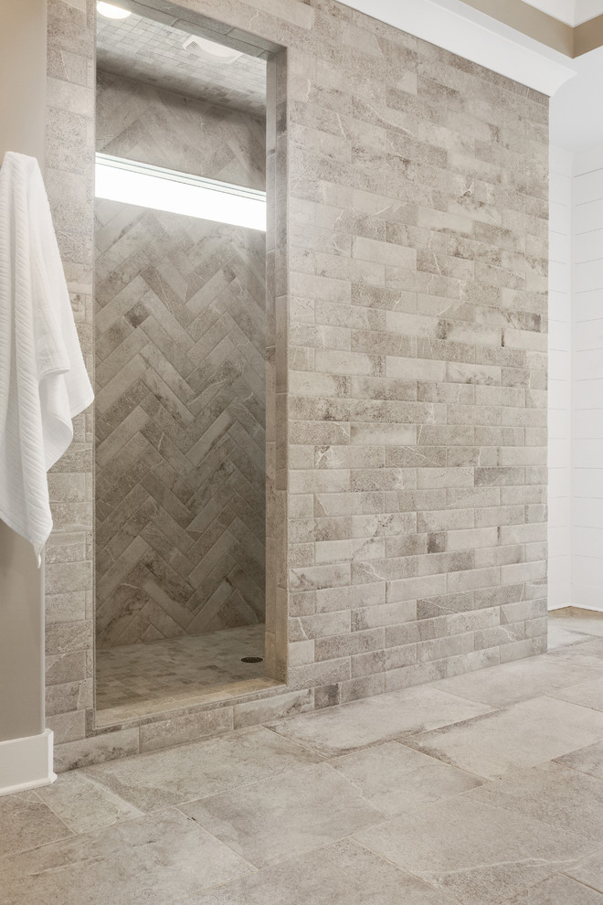 Inspiration for a large transitional master bathroom in Atlanta with recessed-panel cabinets, dark wood cabinets, a freestanding tub, an alcove shower, beige tile, stone tile, white walls, ceramic floors, an undermount sink, granite benchtops, beige floor and grey benchtops.