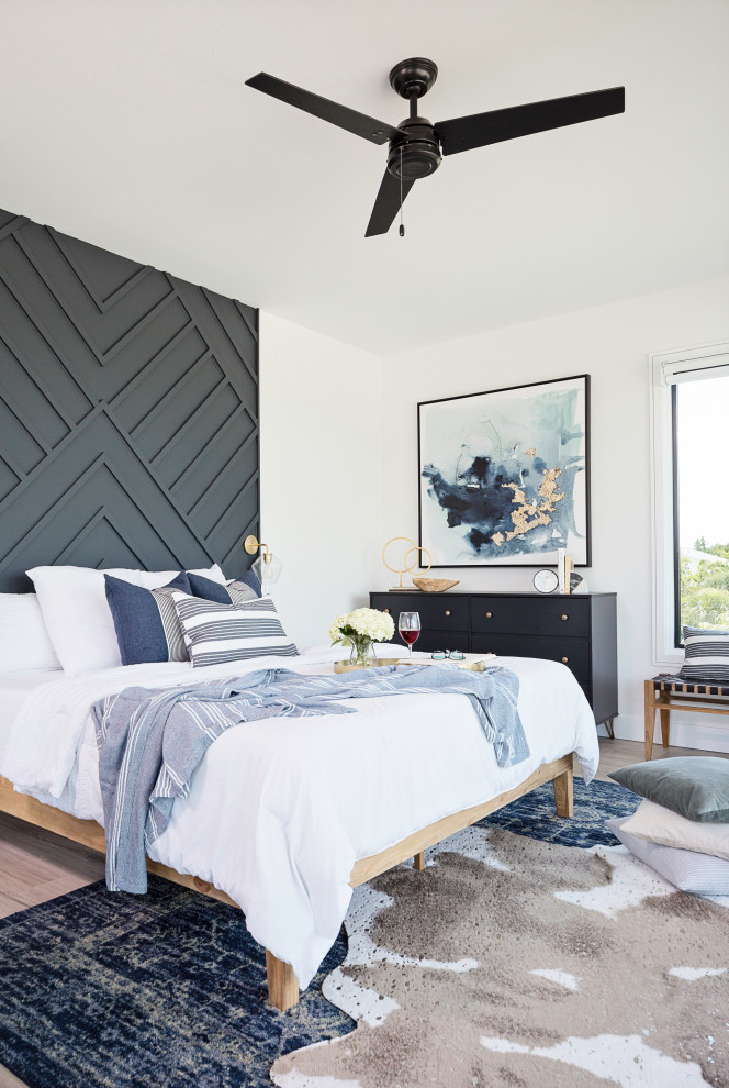 Large transitional master light wood floor and beige floor bedroom photo in Tampa with white walls