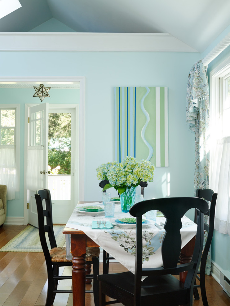 Beach style dining room in Chicago with blue walls and medium hardwood floors.