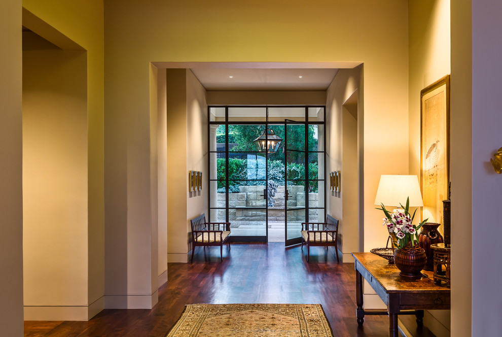 This is an example of a large modern front door in Santa Barbara with medium hardwood floors, a double front door and a glass front door.