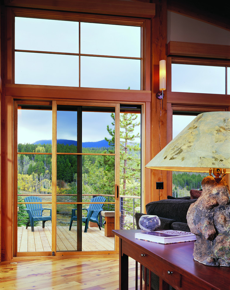 Example of a mid-sized mountain style backyard deck design with no cover