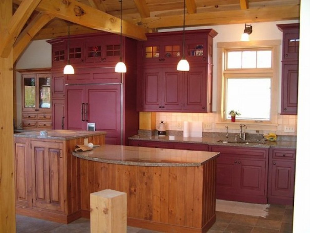 Inspiration for a mid-sized rustic l-shaped ceramic tile eat-in kitchen remodel in Burlington with a double-bowl sink, raised-panel cabinets, red cabinets, granite countertops, beige backsplash, ceramic backsplash, an island and paneled appliances