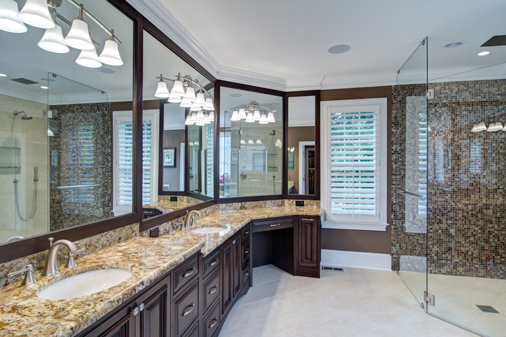 Inspiration for an expansive transitional master bathroom in Atlanta with an undermount sink, raised-panel cabinets, dark wood cabinets, granite benchtops, a curbless shower, multi-coloured tile, mosaic tile, brown walls and porcelain floors.