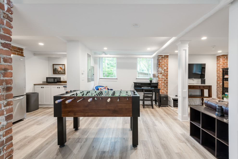 Design ideas for a large arts and crafts walk-out basement in Atlanta with a game room, white walls and brown floor.