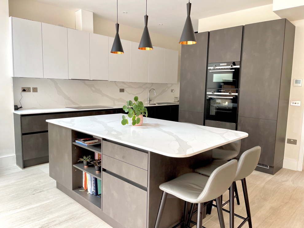 Large contemporary eat-in kitchen in London with flat-panel cabinets, marble benchtops, porcelain floors and with island.