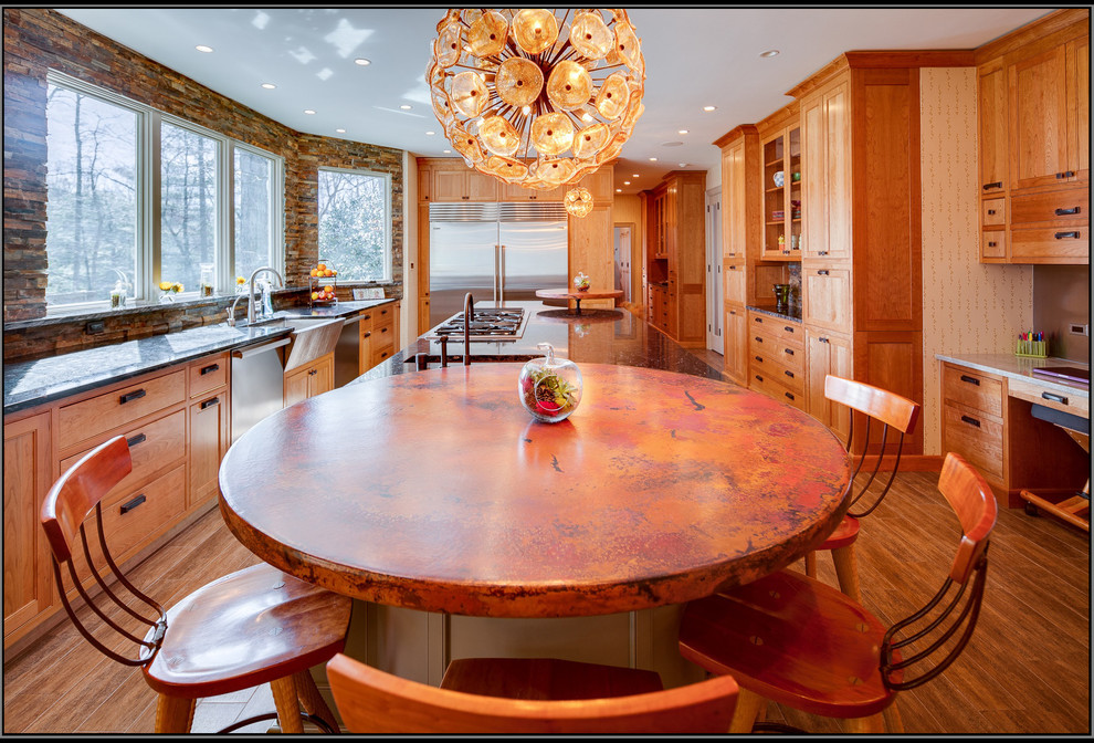This is an example of a large traditional galley eat-in kitchen in DC Metro with a farmhouse sink, medium wood cabinets, onyx benchtops, multi-coloured splashback, stainless steel appliances, medium hardwood floors and with island.