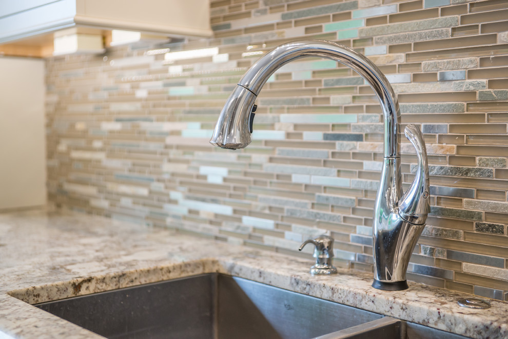 Example of a huge transitional l-shaped medium tone wood floor eat-in kitchen design in Birmingham with an undermount sink, white cabinets, granite countertops, multicolored backsplash, glass tile backsplash, stainless steel appliances, an island and recessed-panel cabinets