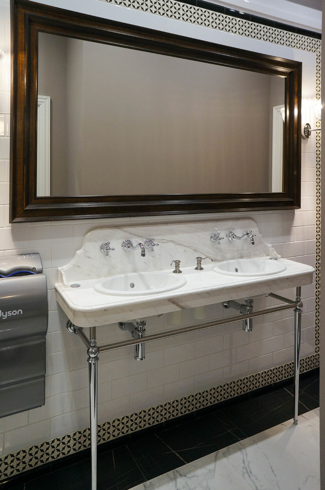 Small traditional powder room in Moscow with a wall-mount toilet, white tile, ceramic tile, brown walls, porcelain floors, a drop-in sink, marble benchtops, white floor and white benchtops.