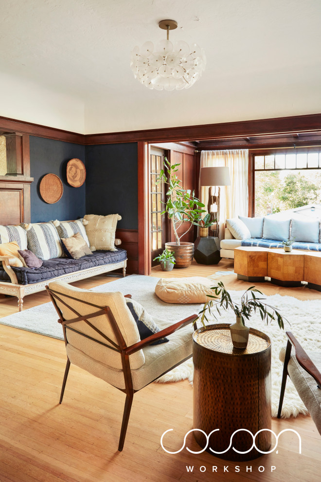 This is an example of a mid-sized modern open concept living room in San Francisco with light hardwood floors, a standard fireplace and a tile fireplace surround.