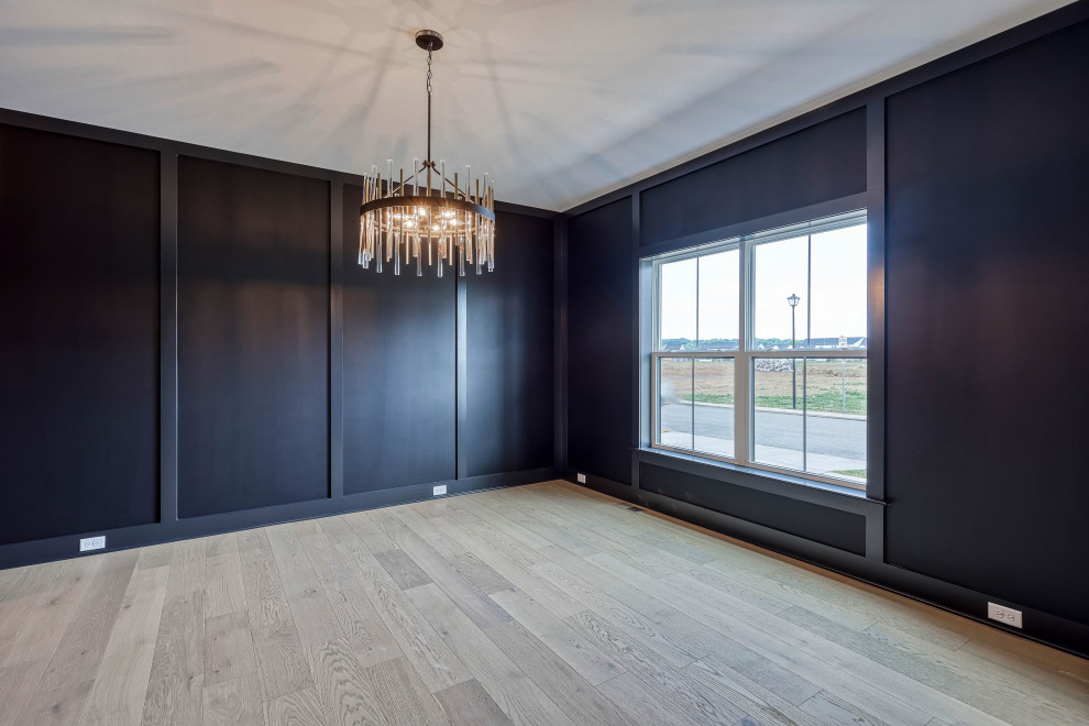 Geschlossenes, Großes Retro Esszimmer mit schwarzer Wandfarbe, hellem Holzboden, Wandpaneelen und braunem Boden in Sonstige