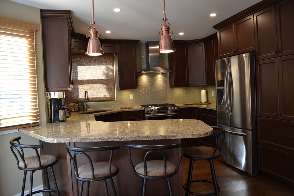 Mid-sized transitional u-shaped medium tone wood floor kitchen pantry photo in Toronto with an undermount sink, recessed-panel cabinets, medium tone wood cabinets, quartz countertops, beige backsplash, glass sheet backsplash, stainless steel appliances and a peninsula