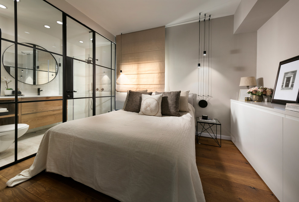 Inspiration for a contemporary master bedroom in Tel Aviv with grey walls, medium hardwood floors and brown floor.